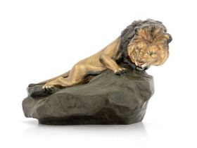 A Royal Doulton figure of a lion on a rock, HN2461, gloss and matte glazed, 45cm long