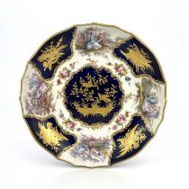 A 'Sevres' porcelain plate or dish, soft paste relief moulded basket weave border of alternating