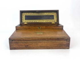 A Regency rosewood writing compendium, circa 1820, brass inlaid, caddy top with a concealed velvet
