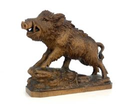 A Black Forest carved wood figure of a boar, 19th century, realistically modelled on a rocky