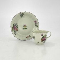 A Worcester polychrome fluted coffee cup and saucer, circa 1770, painted with floral sprigs and