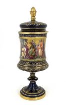 A Vienna porcelain pedestal cup and cover, Campana chalice form, painted in the round with Karl