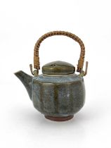 Margaret Frith (British, 1943), a cut-sided stoneware teapot with a cane handle, decorated with a