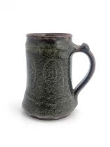 Gugong Bong, an Abuja studio pottery mug, circa 1967-71, tankard form, tenmoku glazed with spiral