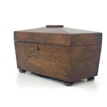 A Regency rosewood tea caddy, circa 1820, of sarcophagus form, fitted interiors with twin lidded