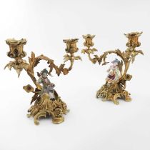 A pair of Meissen style figural porcelain and gilt metal twin branched candelabra, circa 1840, the
