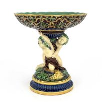 A Minton majolica figural comport, 1863, modelled as two Bacchanalian putti on a vine moulded