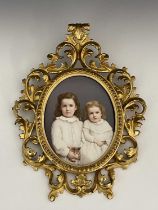 A KPM porcelain plaque, oval form, decorated with portraits of two children in sashed white dresses,