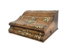 A mid-Victorian burr walnut writing slope, circa 1860, of serpentine form, pierced brass Gothic