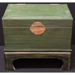 A Chinese style green leather bound chest, raised on wooden stand, twin brass handles, H.36cm L.51cm