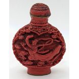 An early 20th century Chinese red lacquer snuff bottle depicting a maiden in robes, character