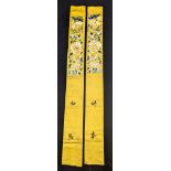 A pair of 19th century Chinese embroidered textile segments, floral embroidery on a yellow ground,