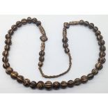 An Indian, Burmese or Tibetan Dzi or Pumtek bead necklace