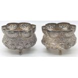 A pair of 19th century Indian silver pots, Lucknow, pierced uppers, the bodies embossed with flora