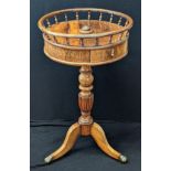 A 19th century walnut drum table