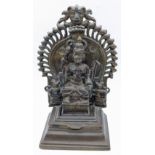 An 18th century Indian bronze of Durga on a Tiered base with backing plate, H.19.5cm