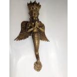 A large Nepalese or Indian brass winged Aspara Temple door handle, circa 20th century, H.46cm
