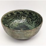 A very fine and rare 12-13th century Persian (Garus ware) green glazed pottery bowl with a human