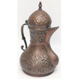 A late 19th century Ottoman Turkish Tombak copper coffee pot with embossed decoration, traces of
