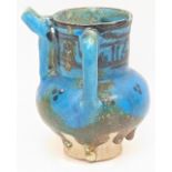 A rare 12th century Syrian raqqa turquoise glazed miniature pouring vessel, H.11cm W.8cm