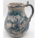 A 10th-12th century large Islamic green glass jug with original patina, H.17cm,