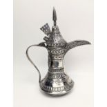 An early 20th century Omani Arab silver coffee pot (Dallah), engraved with calligraphic and stylised