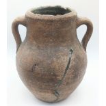 A 10th century Middle Eastern unglazed twin handled pot, H.23cm