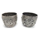 A fine pair of 19th century Burmese silver bowls, embossed stylised decor of dancers, each bearing