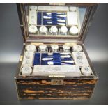 A Victorian traveling coromandel wood vanity case, fitted with silver topped glass containers,