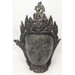 A large bronze Buddha head mounted with red and turquoise stones, inscription to back of head, H.