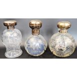 Three Edwardian glass and silver topped scent bottles, 2 intaglio glass bodies, 1 with blue