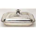 An early 20th century silver tureen, two internal trays, embossed designed lid with screw handle,