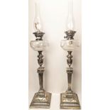 A pair of large Walker & Hall silver and glass oil lamps, Neo Classical style stems, the glass bowls