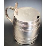 A George III silver barrel mustard pot, family crest to lid, blue glass liner, hallmarked London,