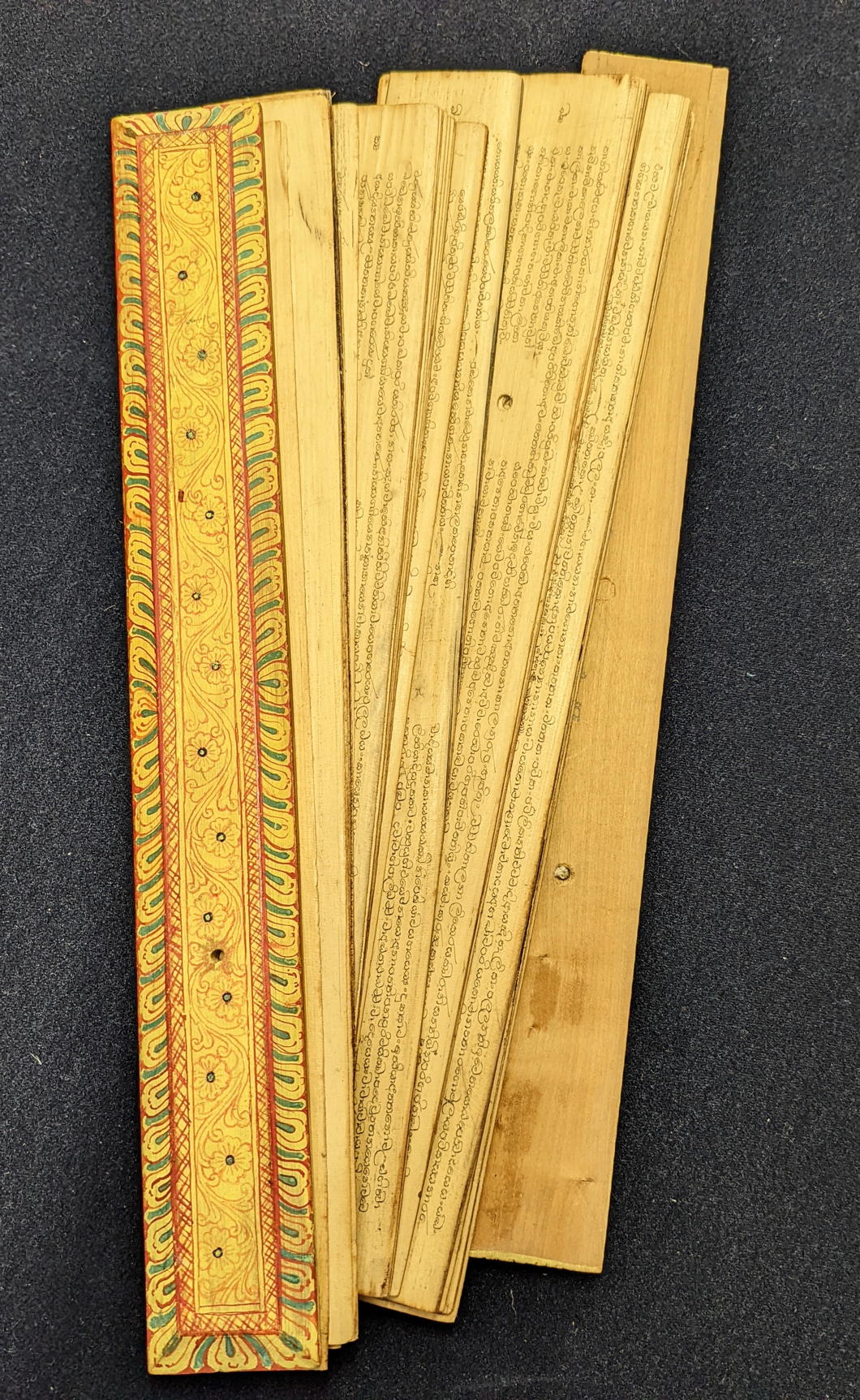 A late 19th/ early 20th century Sinhalese palm leaf manuscript with painted wooden covers, Sri