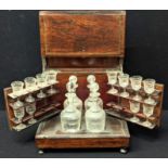 A 19th century mahogany box containing two decanters and a set of glasses