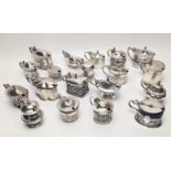 A collection of 19 Edwardian silver mustard pots, all with glass liners, all British hallmarks,