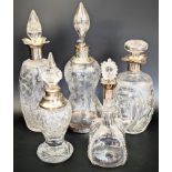 A collection of 5 Edwardian silver and glass decanters, British hallmarks