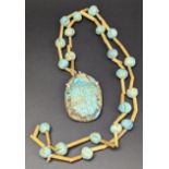 A possibly ancient Egyptian large faience scarab mounted in a possibly layer necklace