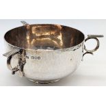An Arts and Crafts three handled silver bowl, planished finish, hallmarked London, 1902, maker