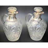 A pair of late Victorian silver and glass wine carafes, etched bodies in the Grecian style with