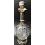A late Victorian silver and glass decanter, repousse embossed stopper and body, vacant cartouche,