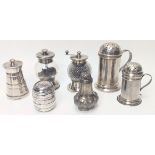 A collection of silver pepperettes and pepper mills