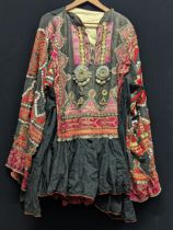 A Middle Eastern or North African traditional dress mounted with coins, buttons, metalwork and