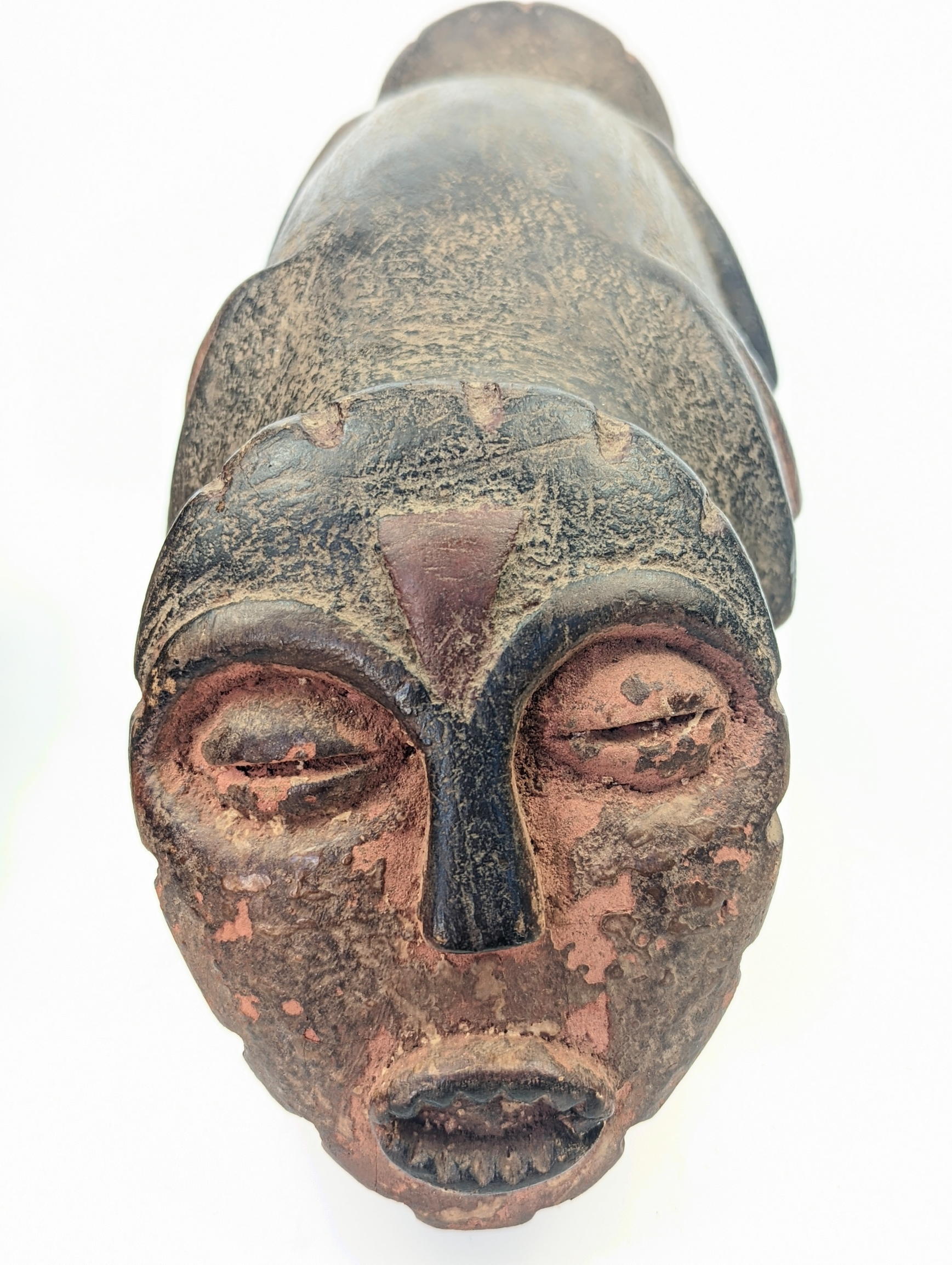 An African tribal Janus helmut, twin face masks on each end, L.39cm - Image 2 of 2