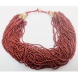 An Indian or Burmese red glass bead Naga necklace, circa 20th century,