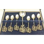 A cased set of 7 palm tree spoons, each stamped 900