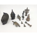 Group of brass and metalware figures, including an Ashanti weight, a dragon, and a Hindu Deity