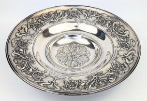 A large 20th century Italian Unoaerre silver dish, repousse embossed, raised on 3 splay feet,