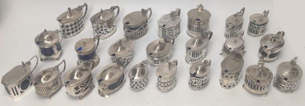 A collection of Edwardian silver mustard pots, most with glass liners, total silver weight 800g (